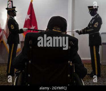 Pvt. Roosevelt Ruffin, a former Army Soldier who served with Company C, 614th Tank Destroyer Battalion, during World War II, looks on as a flag is folded at his 100th birthday celebration Feb. 1, 2020, in Virginia Beach, Virginia. Ruffin was one of the very first African-American tank destroyer unit members of the war. (U.S. Army Reserve photo by Sgt. 1st Class Javier Orona) Stock Photo