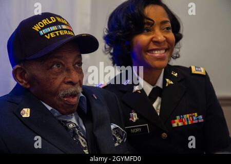 Pvt. Roosevelt Ruffin, a former Army Soldier who served with Company C, 614th Tank Destroyer Battalion, in World War II, poses for a photo with Capt. Chianti Ivory, who works for the Army Reserve Staff at Fort Belvoir, Virginia, during his 100th birthday celebration, Feb. 1, 2020, in Virginia Beach, Virginia. Ruffin was one of the very first African American tank destroyer unit members of the war. (U.S. Army Reserve photo by Sgt. 1st Class Javier Orona) Stock Photo