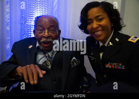 Pvt. Roosevelt Ruffin, a former Army Soldier who served with Company C, 614th Tank Destroyer Battalion, in World War II, poses for a photo with Capt. Chianti Ivory, who works for the Army Reserve Staff at Fort Belvoir, Virginia, during his 100th birthday celebration Feb. 1, 2020, in Virginia Beach, Virginia. Ruffin was one of the very first African-American tank destroyer unit members of the war. (U.S. Army Reserve photo by Sgt. 1st Class Javier Orona) Stock Photo