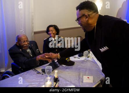 Pvt. Roosevelt Ruffin, a former Army Soldier who served with Company C, 614th Tank Destroyer Battalion, in World War II, greets his son, Calvin, during his 100th birthday celebration Feb. 1, 2020, in Virginia Beach, Virginia. Ruffin was one of the very first African-American tank destroyer unit members of the war. (U.S. Army Reserve photo by Sgt. 1st Class Javier Orona) Stock Photo