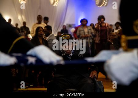 Pvt. Roosevelt Ruffin, a former Army Soldier who served with Company C, 614th Tank Destroyer Battalion, during World War II, looks on as a flag is folded at his 100th birthday celebration Feb. 1, 2020, in Virginia Beach, Virginia. Ruffin was one of the very first African-American tank destroyer unit members of the war. (U.S. Army Reserve photo by Sgt. 1st Class Javier Orona) Stock Photo