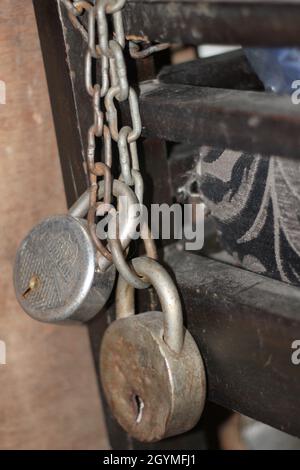 two old locks with chain, gray colored Stock Photo
