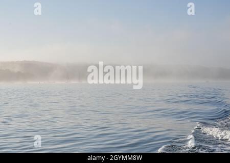 Early summer morning fog scene in Port Jefferson Harbor, Long Island, NY. Copy space. Stock Photo