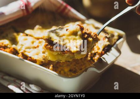 Shepherd's pie in white baking dish on the table Stock Photo