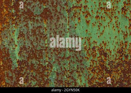 peeled off green paint on flat rusted sheet metal surface Stock Photo