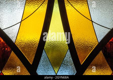 Embossed painted glass with metal separated sections. Geometric shapes with colored glass Stock Photo