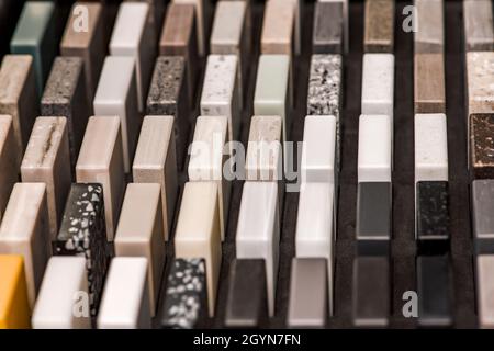 Samples of decorative artificial stone, close-up. Stone samples for kitchen countertops or bathroom, modern interior design Stock Photo