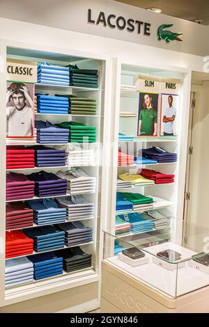 Tarragona El Corte Ingles,department store,interior inside shelves shopping,men's clothing polo shirts designer Lacoste display sale Stock Photo -