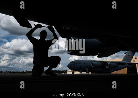 Tech Sgt. Jacob Liebel, 911th Aircraft Maintenance Squadron communication and navigation systems technician, tightens bolts on a C-17 Globemaster III flare panel using a torque wrench at the Pittsburgh International Airport Air Reserve Station, Pennsylvania, Oct. 8, 2021. The torque wrench is used to ensure bolts are tightened to the necessary value to keep them locked in place. (U.S. Air Force photo by Joshua J. Seybert) Stock Photo