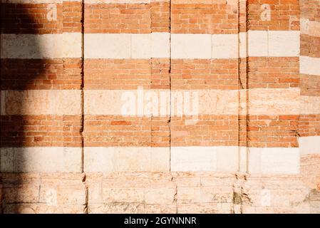 Background and texture of the traditional Italian two-color brick wall. Stock Photo