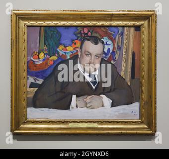 Tempera painting 'Portrait of Ivan Abramovich Morozov' by Russian Impressionist painter Valentin Serov (1909) on display at the exhibition 'Icons of Modern Art from the Morozov Collection' in the Fondation Louis Vuitton in Paris, France. Ivan Abramovich Morozov was a Russian art collector owned one of the best collections of French modernist art in the world. Painting 'Fruits and Bronze' by French painter Henri Matisse (1910) from his collection is depicted in the background of the portrait. The exhibition devoted to the Morozov Collection runs till 22 February 2022. Stock Photo