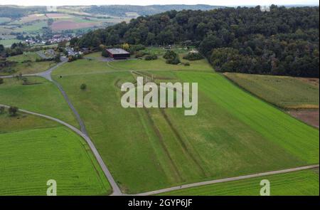 Hessen, Germany. 08th Oct, 2021. 08 October 2021, Hessen, Glauburg: A reconstructed burial mound, the section of a processional road and a group of enigmatic wooden posts are among the archaeological traces from the time of the Celts over 2,400 years ago that can be discovered on the Glauberg and its museum (aerial view with a drone). In 1994, a research team had begun excavations and discovered, among other things, the now world-famous statue of the 'Celtic Prince of the Glauberg'. The Celtic settlement in the Wetterau region is to become a Unesco World Heritage Site. The federal states have  Stock Photo