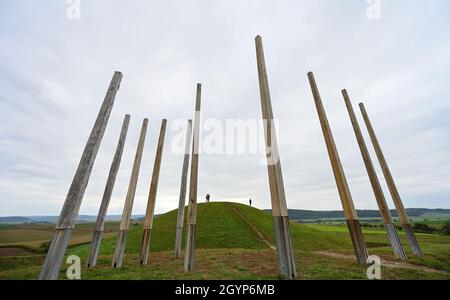 Hessen, Germany. 08th Oct, 2021. 08 October 2021, Hessen, Glauburg: A reconstructed burial mound and a group of enigmatic wooden posts stand in the Celtic World Archaeological Park on the Glauberg. In 1994, a research team had begun excavations and discovered, among other things, the now world-famous statue of the 'Celtic Prince of the Glauberg'. The Celtic settlement in the Wetterau is to become a Unesco World Heritage Site. The federal states have to submit their proposals for the national preselection procedure to the Conference of Ministers of Culture by October 31. (to dpa 'May settlement Stock Photo