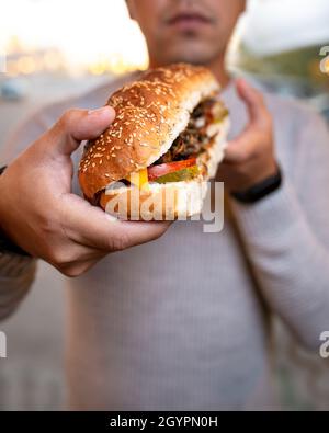 the guy wants to bite off a sandwich. Stock Photo