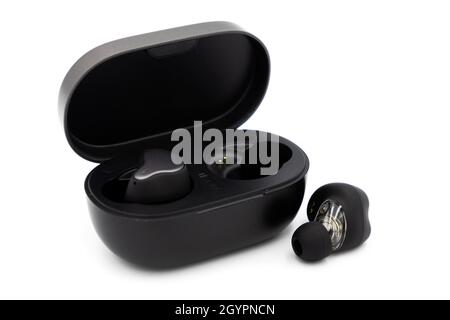 Pair of true wireless earbuds and case isolated on white background Stock Photo