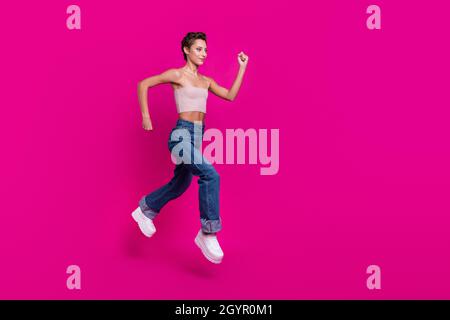 Full size profile side photo of charming attractive woman jump run sale empty space cool isolated on magenta color background Stock Photo