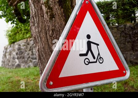 Warning traffic sign - child on scooter alert Stock Photo