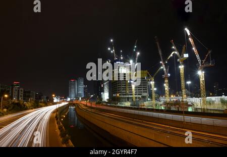 Israel, Tel Aviv, Long exposure Night shot of Ayalon highway with light trails. Azrieli high rises in the background Stock Photo