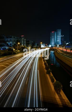 Israel, Tel Aviv, Long exposure Night shot of Ayalon highway with light trails. Azrieli high rises in the background Stock Photo