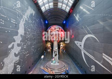 The Earth Hall with escalator leading up into the red globe, Natural History Museum, South Kensington, London, England Stock Photo