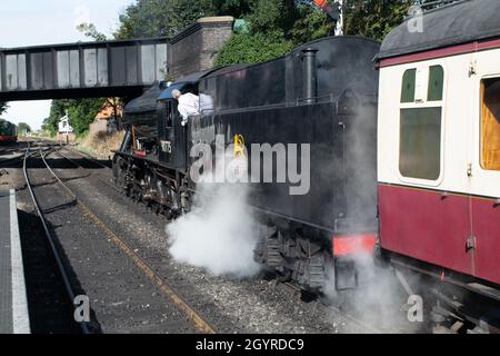 Sheringham, Norfolk, UK - SEPTEMBER 14 2019: Driver of a 1943 WD 2-10-0 – 90775 ‘The Royal Norfolk Regiment’ train with head out of train Stock Photo
