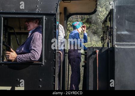 Sheringham, Norfolk, UK - SEPTEMBER 14 2019: Woman in vintage locomotive train engineer uniform on a 1943 WD 2-10-0 – 90775 ‘The Royal Norfolk Regimen Stock Photo