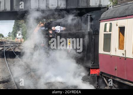 Sheringham, Norfolk, UK - SEPTEMBER 14 2019: Driver and engineer look out of a 1943 WD 2-10-0 – 90775 ‘The Royal Norfolk Regiment’ train covered in st Stock Photo