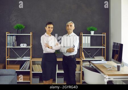 Portrait of two serious confident business professionals standing in their office Stock Photo
