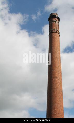 A Tall Traditional Red Brick Industrial Chimney. Stock Photo