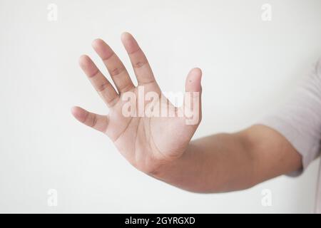 young man show stop sigh isolated on white  Stock Photo