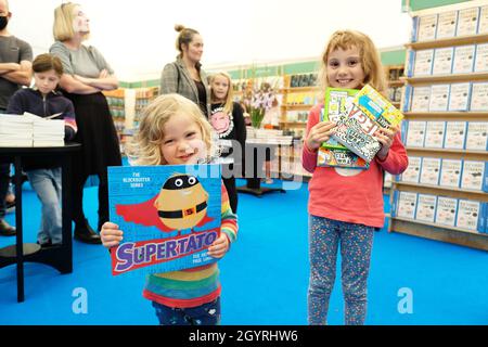 Cheltenham Literature Festival, Cheltenham, UK - Saturday 9th October 2021 - Young readers show off their new books inside the Festival bookshop on Day 2 of the Festival - the Festival runs until Sunday 17th October - Photo Steven May / Alamy Live News Stock Photo