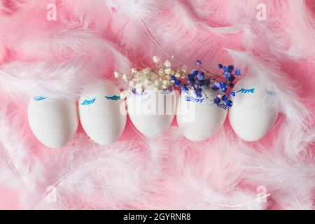 Happy Easter composition with easter eggs, flowers,feathers on pink background Stock Photo