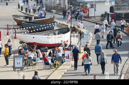Brighton UK 9th October 2021 - Brighton seafront is busy as visitors enjoy a hot sunny day with some parts of the South East forecast to reach over 20 degrees centigrade : Credit Simon Dack / Alamy Live News