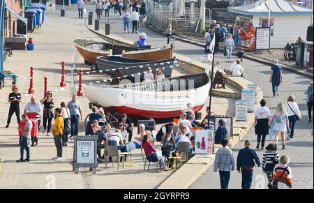 Brighton UK 9th October 2021 - Brighton seafront is busy as visitors enjoy a hot sunny day with some parts of the South East forecast to reach over 20 degrees centigrade : Credit Simon Dack / Alamy Live News