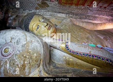 Close up of the reclining Buddha carved out of rock in the Cave of the Divine King, Dambulla Caves, Sri  Lanka on 19 September 2016 Stock Photo