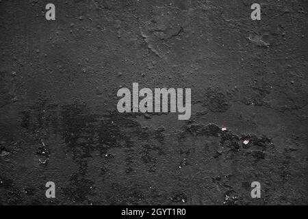 Black coloed plaster wall detail, grunge background or texture Stock Photo