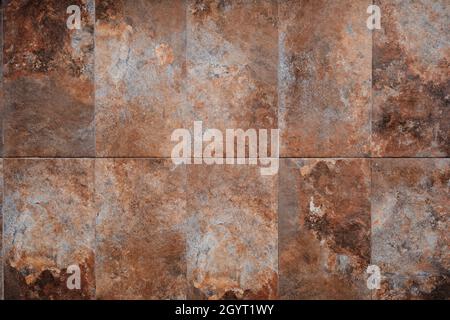Rusty slate stone tiled wall texture or background Stock Photo