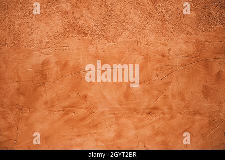 Terracotta colored plaster wall, rustic background or texture Stock Photo