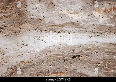 Classic travertine stoneware porcelain tiles, rustic natural stone effect, porous limestone texture detail Stock Photo