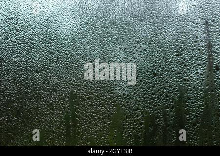 Condensation droplets on a window pane close up Stock Photo