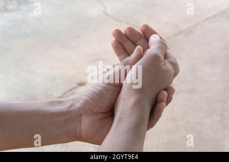 The Asian man who is suffering from wrist pain from exercise Stock Photo