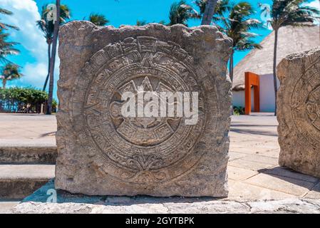 Close up of maya souvenirs carved on stone at pavement in resort Stock Photo
