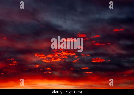 Colorful sunset sky with dramatic red clouds. Only sky image, no land. Stock Photo