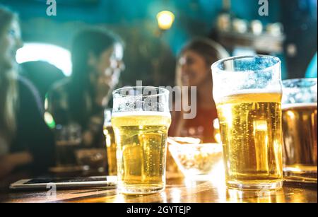 Happy girlfriends women group drinking beer at brewery bar restaurant - Friendship concept with young female friends enjoying time and having genuine Stock Photo