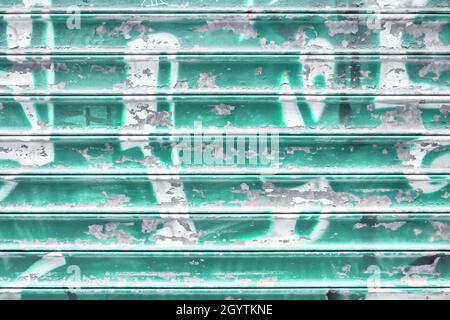 Turquoise metal shutter with peeling paint. Ideal use for background / wallpaper. Stock Photo