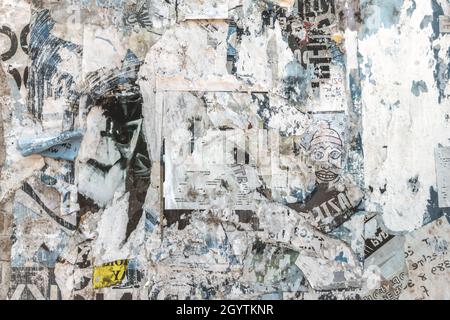 Grunge background with old torn posters. Multicolor texture. Stock Photo