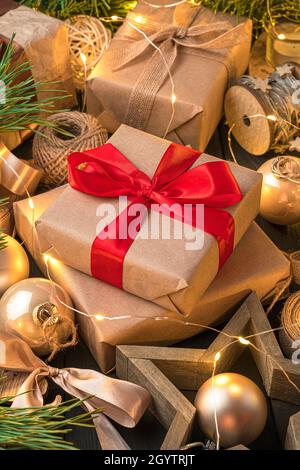 Gift boxes with red ribbons on a festive background. Side view, close-up. The concept of Christmas, New Year. Stock Photo