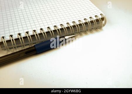 the pen is on the table next to the notebook Stock Photo