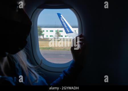 a passenger is looking through the airplane window Stock Photo
