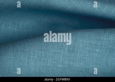 Linen fabric, blue background. Soft linen blue fabric texture. Textured fabric background. Macro with shallow dof Stock Photo